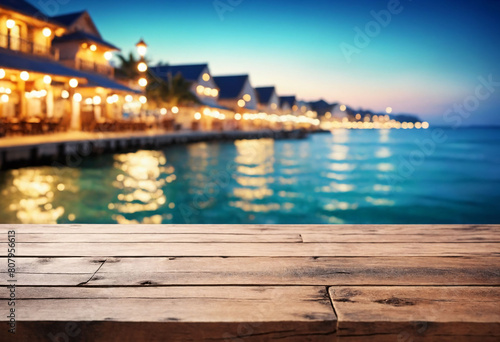 Seaside Serenity, Wooden Table Overlooking Beach Cafes with a Dreamy Bokeh Lights Background © Giuseppe Cammino