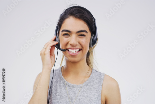 Portrait, woman and sales assistant in studio with smile, headset and happy on white background. Female person, consultant and advisor for support, information and crm with mic for communication