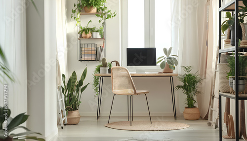 Stylish interior of room with comfortable workplace and houseplants