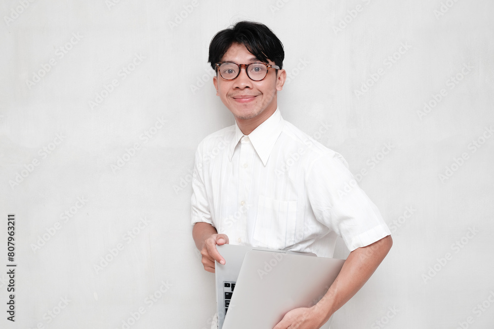 Smiling Student in Glasses Carrying Laptop Smiling Student in Glasses Carrying Laptop