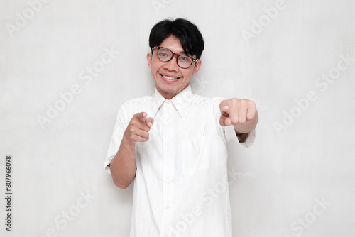 Young Asian man smiling happily while dancing isolated on white photo