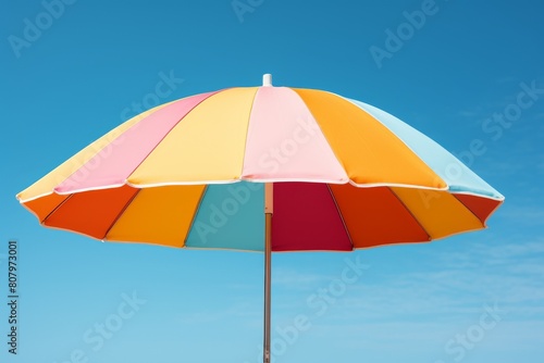 A large, colorful beer garden umbrella, providing shade, displayed on a clear sky blue background, essential for sunny day festivities.