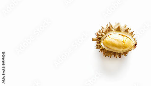 A large, yellow durian fruit with a white spot on it