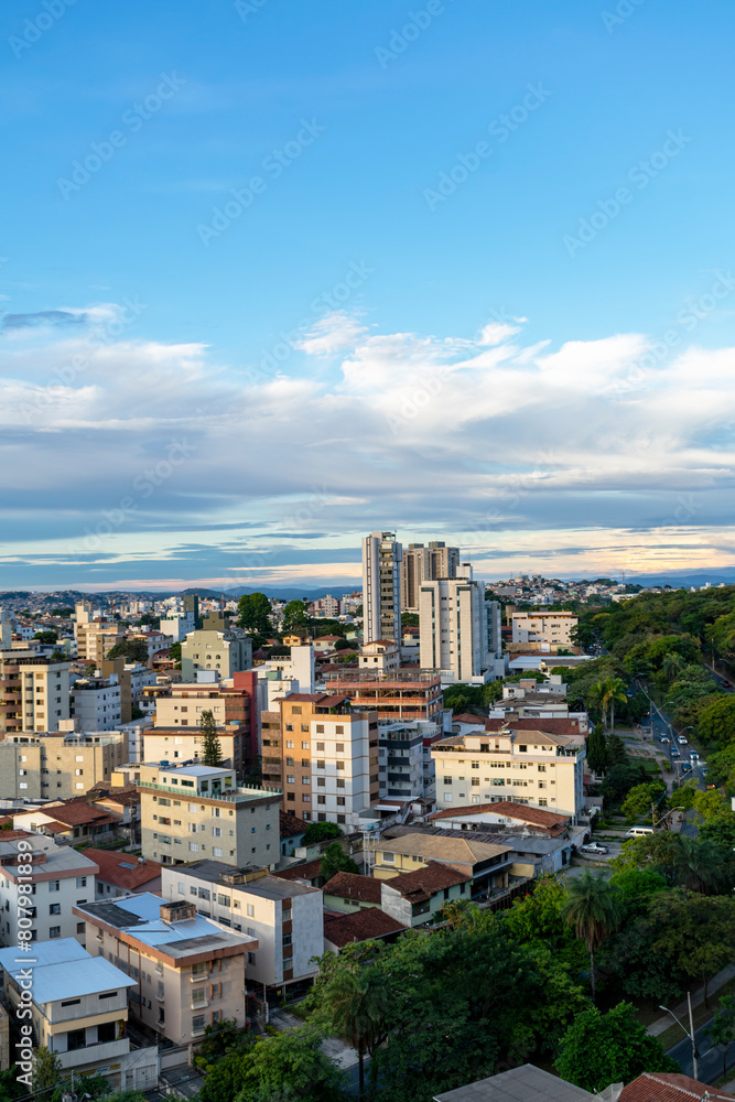 Residential buildings seen from above in the city of Belo Horizonte. Beautiful blue sky with clouds. Vehicle traffic. Vertical.