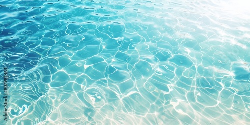  transparent water in a swimming pool  with a clear blue sea background showing ripples and reflections.  sunlight shining on the surface of clean turquoise water.minimalist summer abstract  
