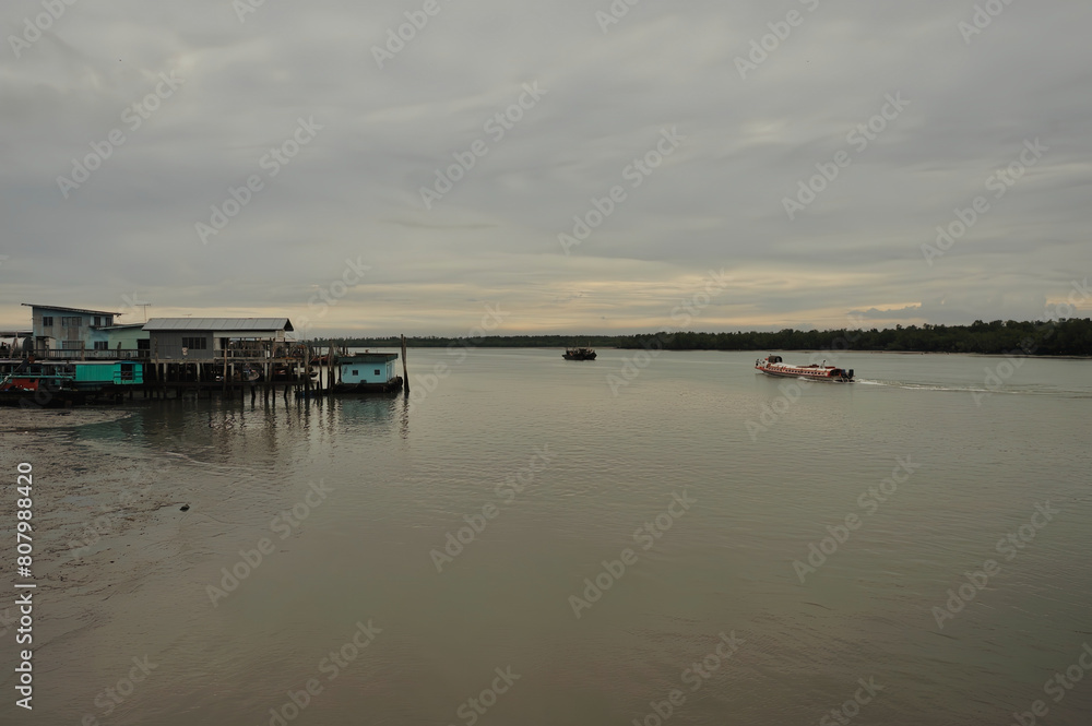 passenger ferry docked at pier people disembarking calm water hazy sky