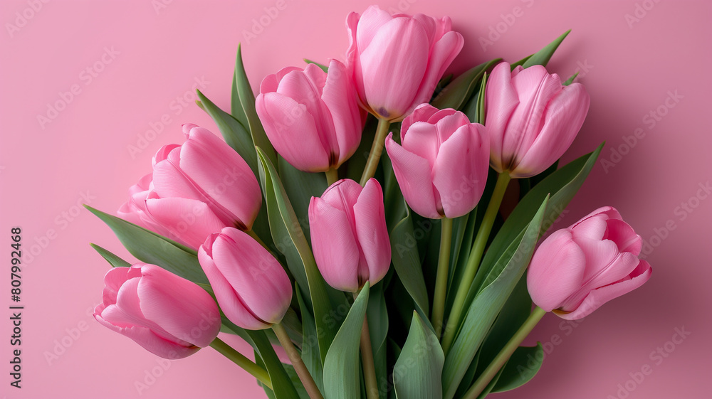A bouquet of pink tulips is arranged in a vase A bouquet of pink tulips is arranged in a vase
