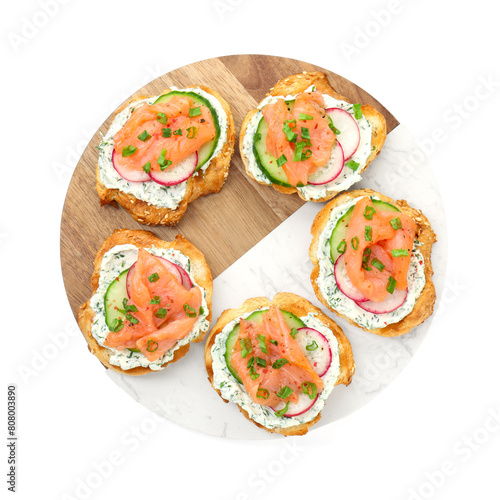 Tasty canapes with salmon, cucumber, radish and cream cheese isolated on white, top view