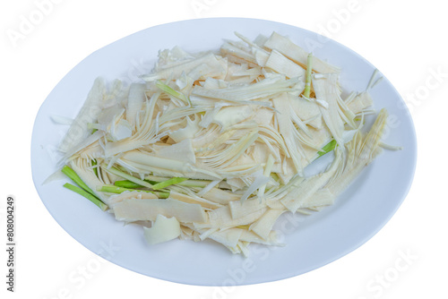Bamboo shoots cut into pieces on a plate on a white background.