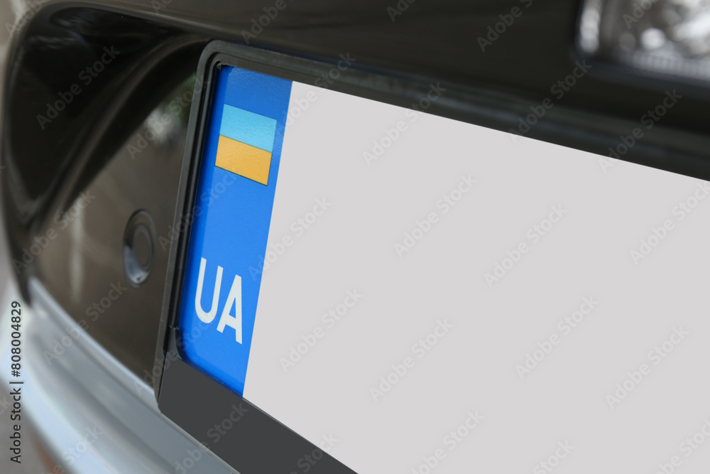 Fototapeta premium Car with vehicle registration plate, closeup view