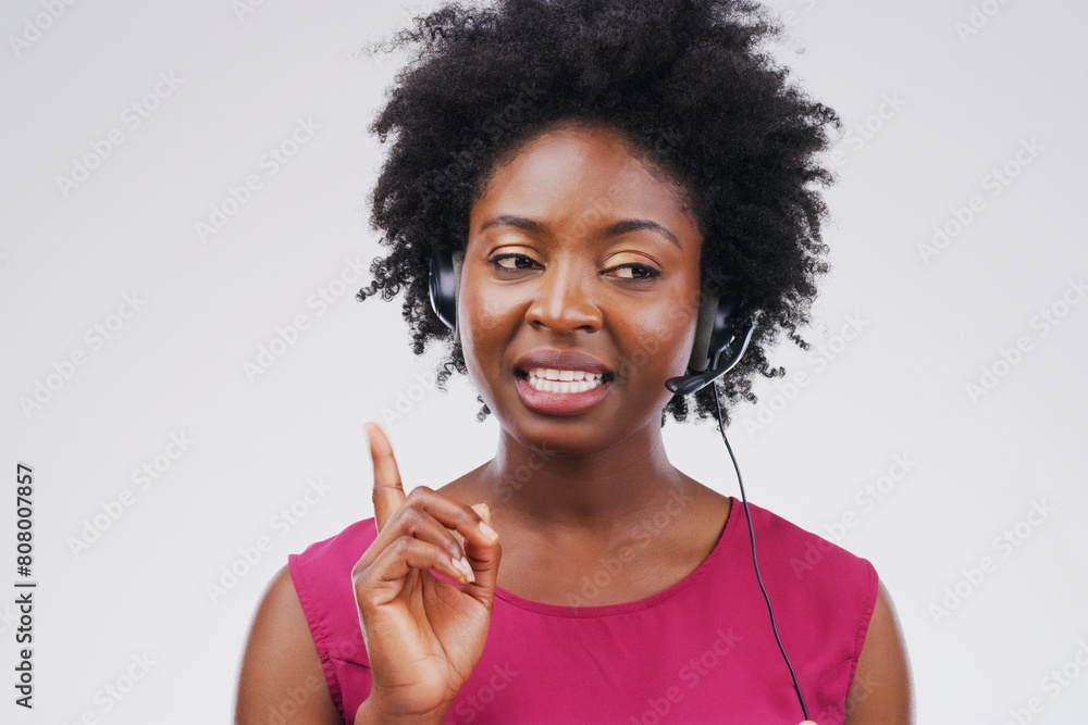 Black woman, talking or listening with headset in studio background for consultant, call centre or crm. Female person, conversation and headphones with mic for support, connectivity and communication