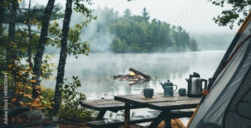 Serene lakeside camping scene with cozy tent and morning coffee setup