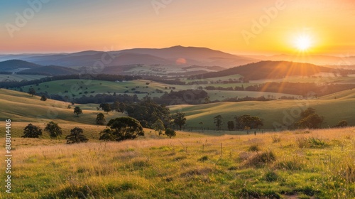 A panoramic view of the sun rising over rolling hills, rural tranquility at dawn © Plaifah