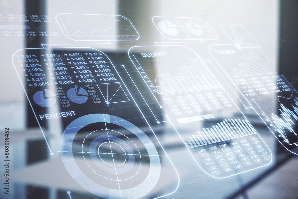 Multi exposure of creative statistics data hologram on laptop background, stats and analytics concept Multi exposure of creative statistics data hologram on laptop background, stats and analytics concept