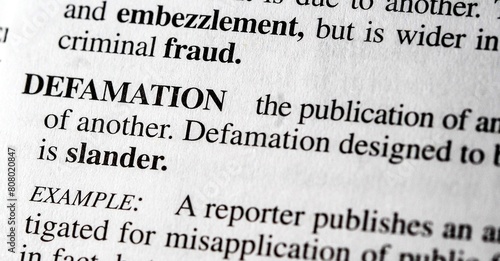 close up photo of the words defamation photo