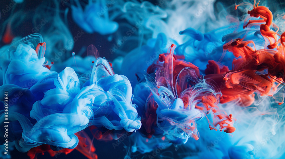 A scene depicting the graceful descent of blue and red ink through clear water, creating a tapestry of color against a dark background. 