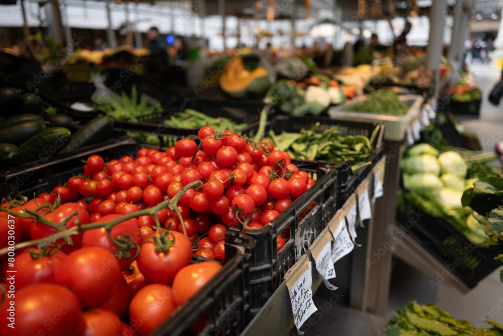 Fresh tomatoes and vegetables on display at porto market during daytime