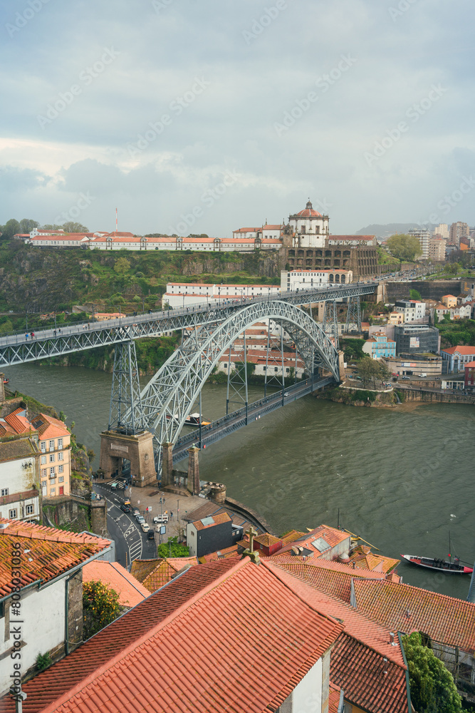A view from a window showing the Don Luis I Bridge stretching over a river