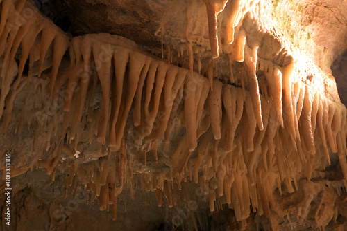 Inside limestone cave - different morphological elements created by driping or flowing water and calsium dioxide: stalagmites, stalactites, pipes, karst landscape, flowstones photo