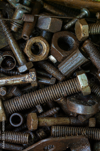 Pile of rustic nuts and bolts in grease,Close-up of a nut with oil stains,