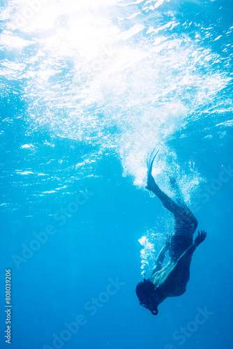 Side View of Young Man Diving into the Deep of the Ocean,Splashing Water