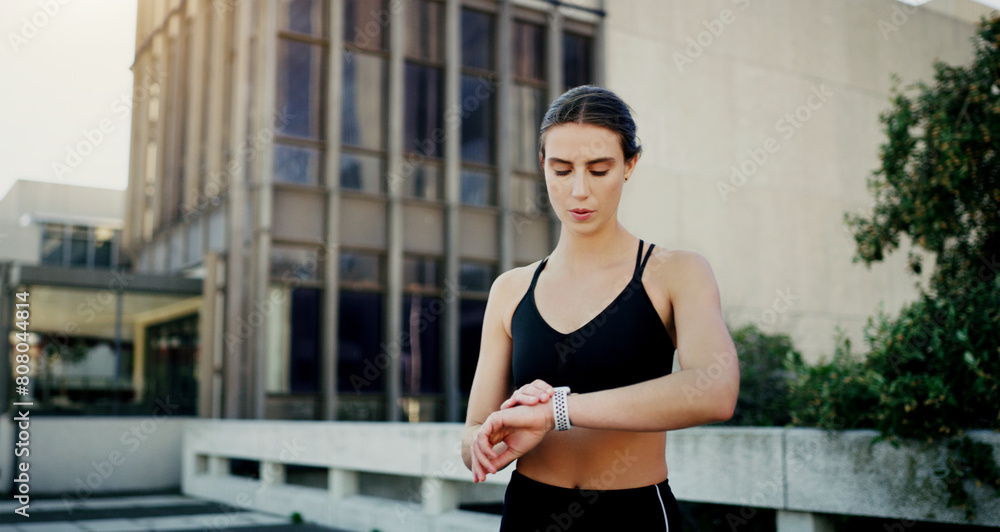 Outdoor, woman or runner with smart watch in city for heart rate to monitor training or exercise progress. Urban, clock or healthy sports athlete with timer technology for running workout or fitness