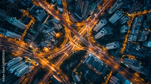 Aerial view of roads and intersections lit up by city lights, urban sprawl