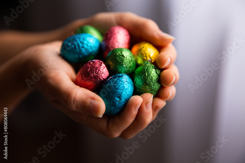 child holding Easter eggs in cupped hands photo