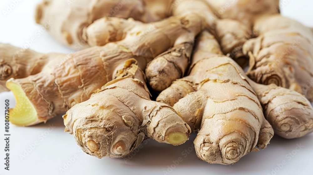 Fresh ginger root with its rough, textured skin, sharply focused against a white background to highlight its natural shapes Fresh ginger root with its rough, textured skin, sharply focused against a white background to highlight its natural shapes