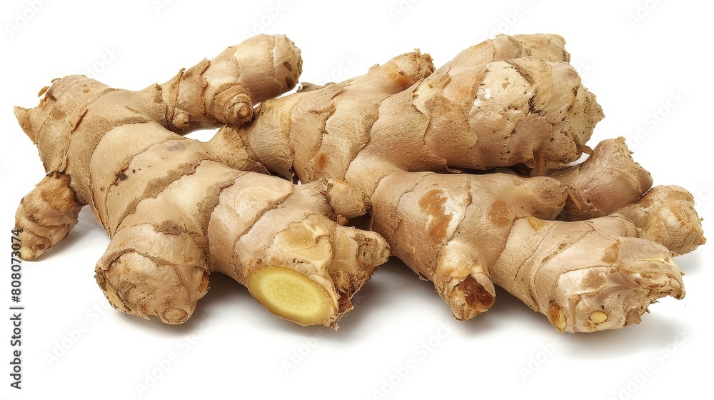 Fresh ginger root with its rough, textured skin, sharply focused against a white background to highlight its natural shapes