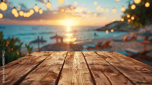An empty wooden table amidst the bustling energy of a beach party, awaiting guests to share drinks and laughter. photo
