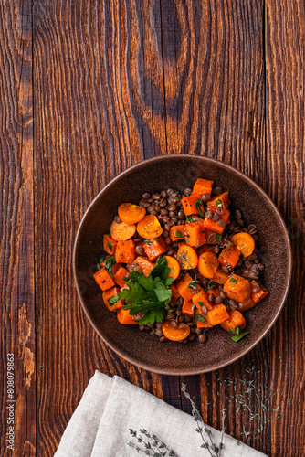 Comfort food with roasted sweet potatoes, lentils and herbs, delicious lunch or dinner, high angle view