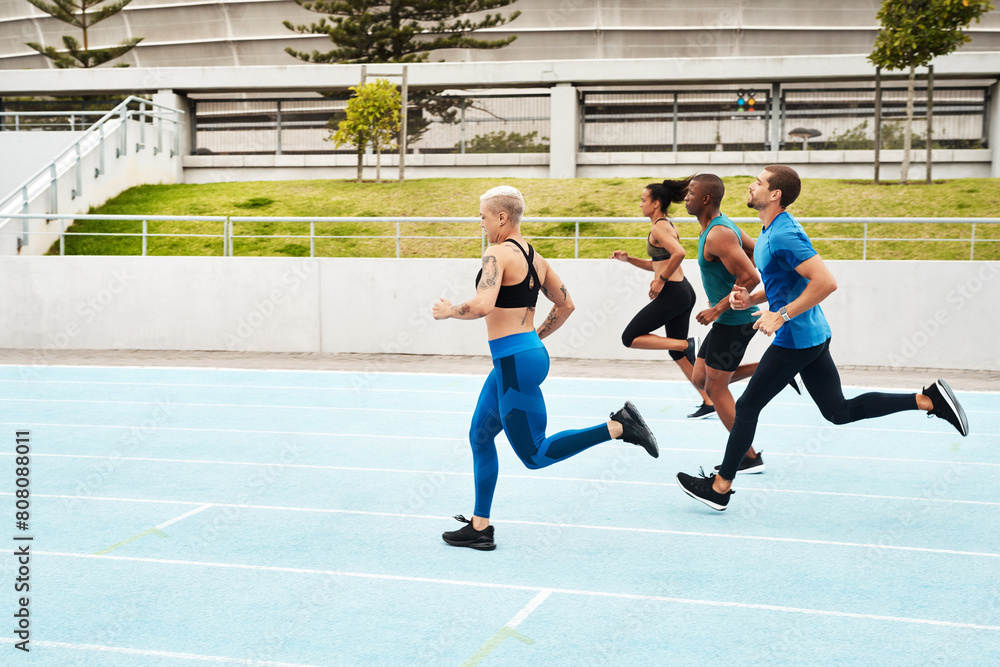 Fototapeta premium Group, people and running in stadium for workout or sport on track, training or exercise for wellness. Team, athlete and arena with runner for freedom or health, commitment and strong with cardio