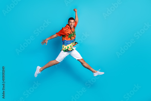 Full body photo of nice young man jump empty space summer holiday isolated on blue color background