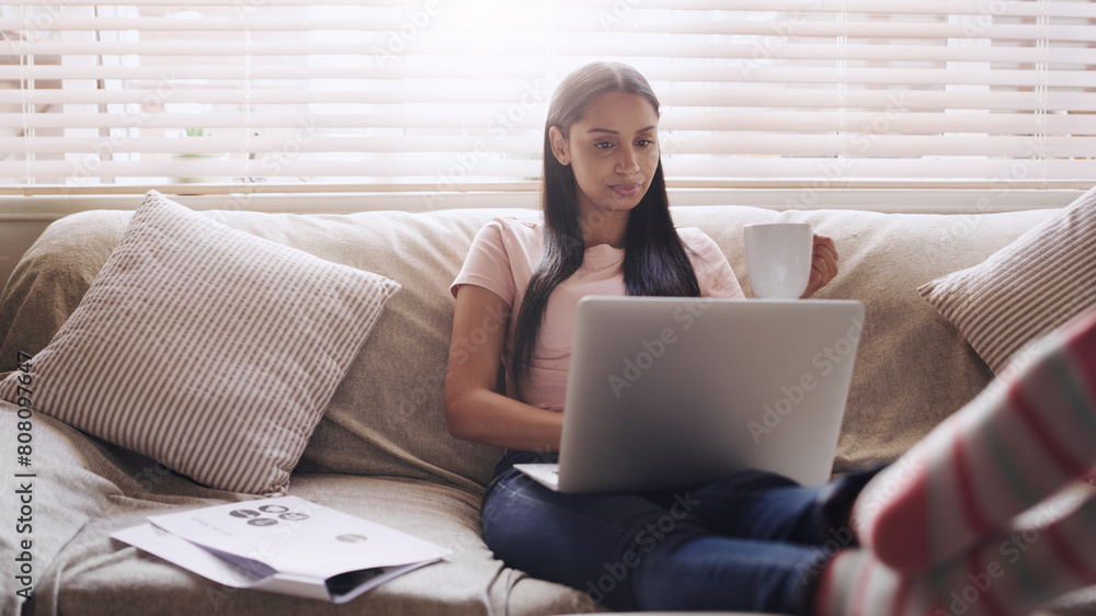 Couch, paperwork and woman with laptop for remote work, relax and typing for online career. Documents, reading and freelancer girl in home with computer for website project, research and networking Couch, paperwork and woman with laptop for remote work, relax and typing for online career. Documents, reading and freelancer girl in home with computer for website project, research and networking