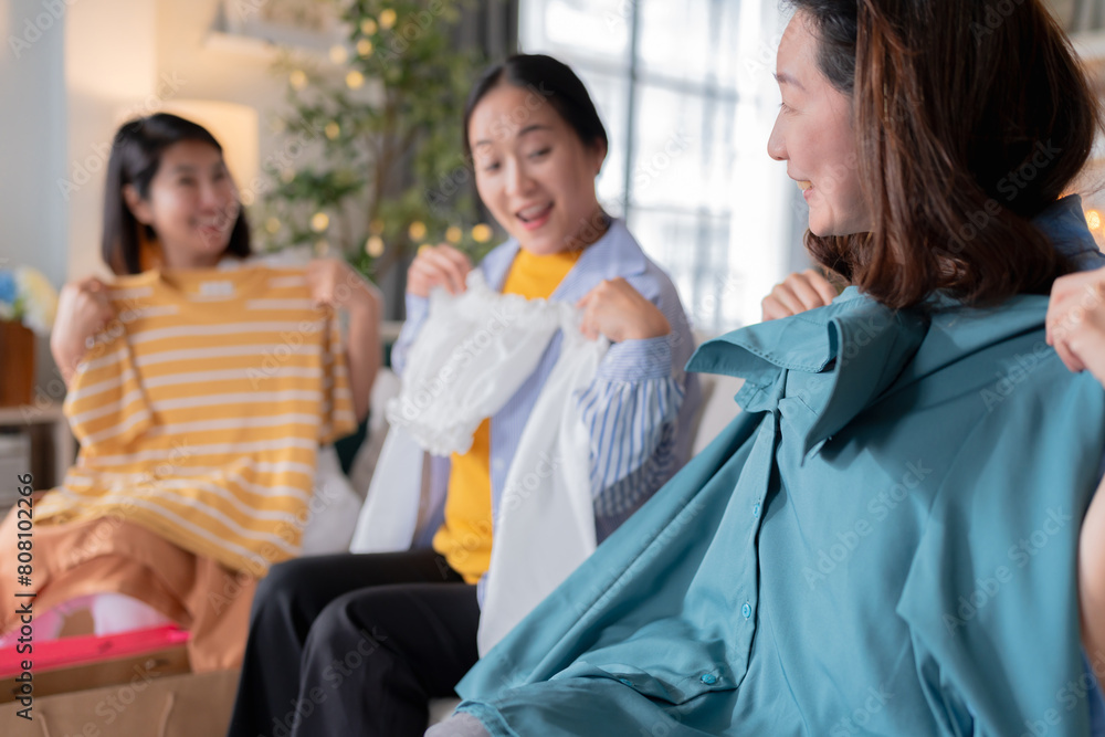 Obraz premium group of asian woman adult friend sit relax enjoy check dress cloth from shopping from paper bag woman enjoy shopping unbox show girl stuff to woman reunion friend home lifestyle party