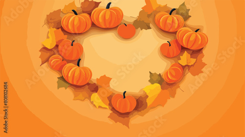 autumn leaves with pumpkin heart frame on orange ba
