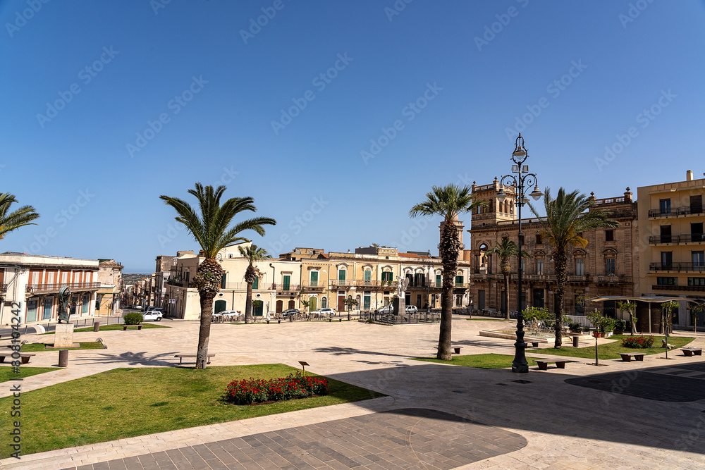 Main square known as Piazza Unità d'Italia in Ispica, a charming town in south-eastern Sicily, under an intensely blue sky