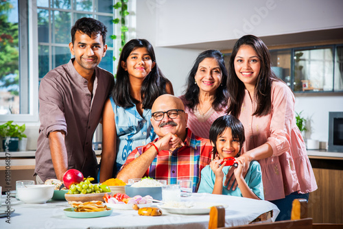 Canvas Print Happy Indian asian family having lunch at home and posing for photo