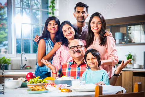 Photography Happy Indian asian family having lunch at home and posing for photo