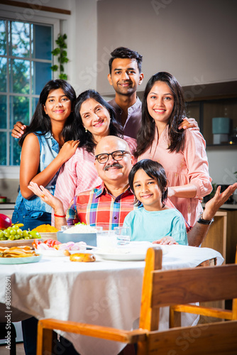 Photography Happy Indian asian family having lunch at home and posing for photo