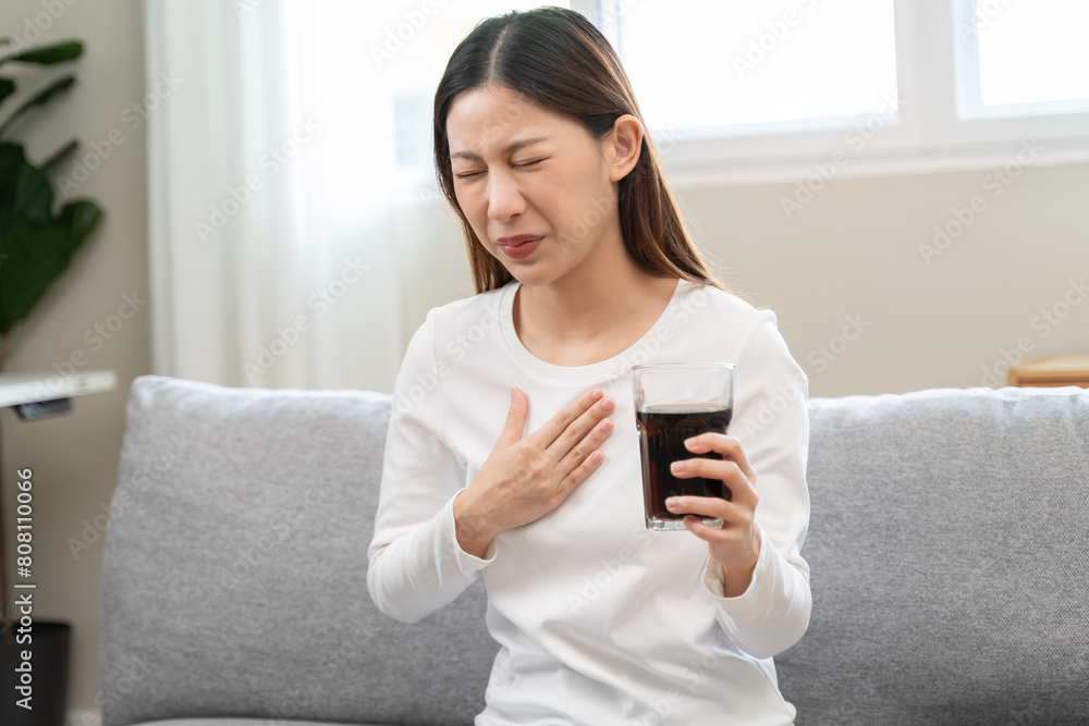 Acid reflux disease, suffer asian young woman have symptom gastroesophageal, esophageal, stomach ache and heartburn pain hand on chest from digestion problem after eat food, Healthcare medical concept Acid reflux disease, suffer asian young woman have symptom gastroesophageal, esophageal, stomach ache and heartburn pain hand on chest from digestion problem after eat food, Healthcare medical concept