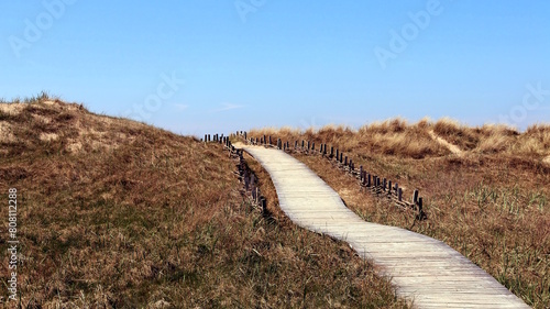 A path of light wood that climbs up the dunes, like a passage to heaven. Lithuania. photo