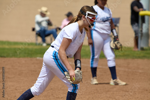 Young Female fastpitch softball player playing club sports. photo