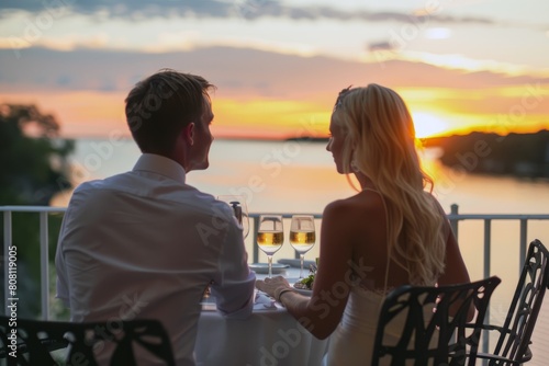 Young couple on a beach at sunset, walking hand in hand along the shoreline, with warm glow of sun