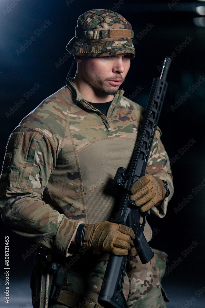 Fototapeta premium In professional shooting range, a military man in ammunition tells how to use a NATO rifle