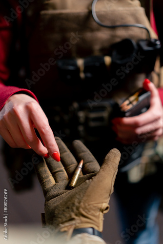 close up At a professional shooting range a guy in tactical ammunition loads a magazine with cartridges