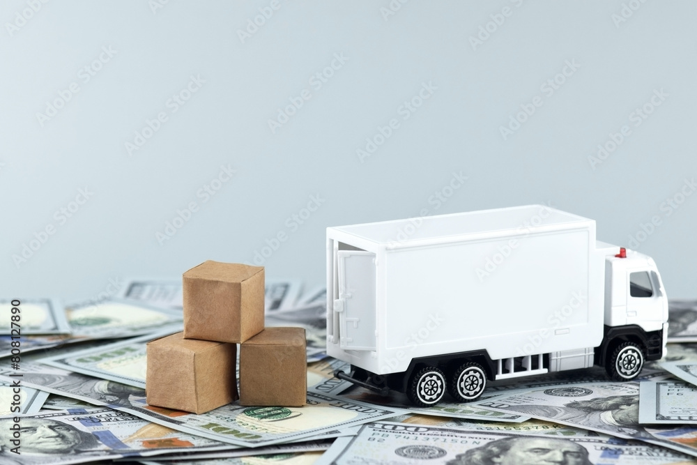 White toy truck with boxes on a light background, space for text. White toy truck with boxes on a light background, space for text.