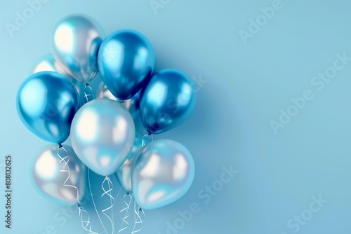 Bunch of shiny blue and silver balloons on a light blue background