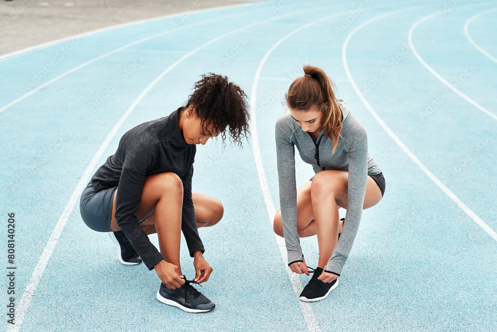 Sports, women and race track in sportswear for training, outdoor or workout in stadium for wellness. Female athletes, shoes and break in exercise for tournament, competition or contest as runners